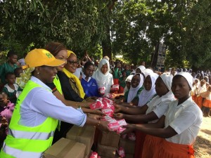 NSSF Trustee Teresia Maina and Ahadi Kenya brand ambassador Cecilia Mwangi donating sanitary towels to the girls in Kilole and Zigira Primary School Ukunda, Kwale County during the jigger clinic.